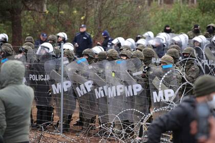 Fuerzas de seguridad polacas desplegadas frente al alambrado de la frontera