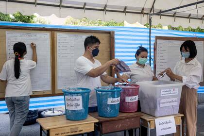 Funcionarios electorales cuentan los votos en un colegio electoral en Bangkok el 14 de mayo de 2023 tras el cierre de las urnas en las elecciones generales de Tailandia. 