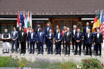 German Chancellor Olaf Scholz (front row, C), G7-leaders and participants of the outreach program pose for a family photo on June 27, 2022 at Elmau Castle, southern Germany, where the German Chancellor hosts a summit of the Group of Seven rich nations (G7). - Germany will host the 48th G7 Summit from June 26 to June 28 at Elmau Castle, southern Germany. (Photo by Ludovic MARIN / POOL / AFP)