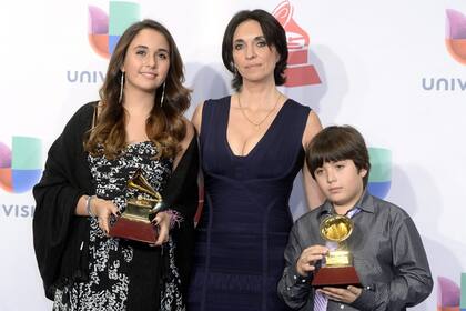 Gabriela Carrasco y sus hijos sostienen los Grammy Latino por el Álbum del Año y Mejor Álbum de Flamenco otorgados a su esposo y padre fallecido, el músico y compositor español Paco De Lucia