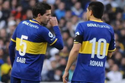 Gago y Riquelme dialogan durante un partido de Boca, en 2014