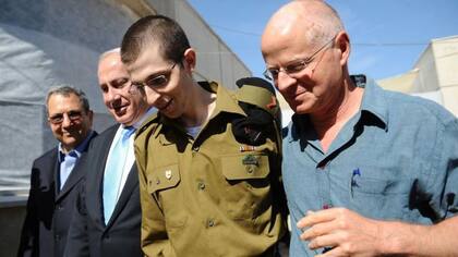 Gilad Sahlit, en la foto con su padre Naom (a la derecha), y con el entonces ministro de Defensa israelí Ehud Olmert y el primer ministro Benjamín Netanyahu, fue liberado por Hamás a cambio de 1.027 presos palestinos
