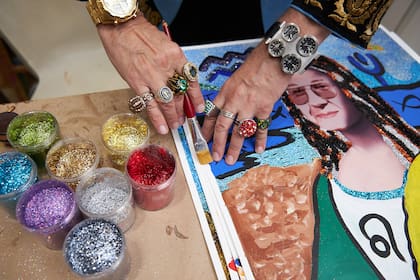 Glitter, joyas y relojes en un detalle de su mesa de trabajo