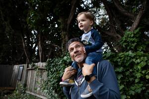 Gonzales plays in the backyard with his 2-year-old grandson, Sandy. When Gonzales was diagnosed with mild cognitive impairment two years ago, "I immediately thought, 'I'm dying tomorrow,' " he said. Over time, he emerged from depression. MUST CREDIT: Photo for The Washington Post by Cassandra Giraldo.