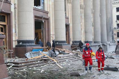 Los paramédicos se alejan del edificio de la Administración Estatal Regional de Kharkiv después de que fuera alcanzado por un ataque con misiles rusos