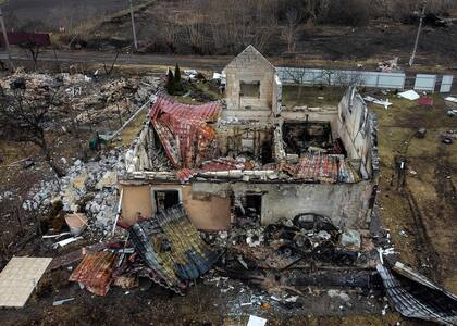TOPSHOT - This aerial view taken near Kyiv on March 30, 2022 shows a destroyed house in the village of Lukianivka