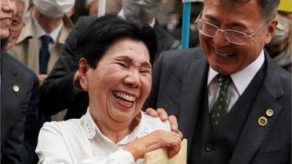 Hideko Hakamada comparte una sonrisa con un abogado de su hermano fuera de la corte