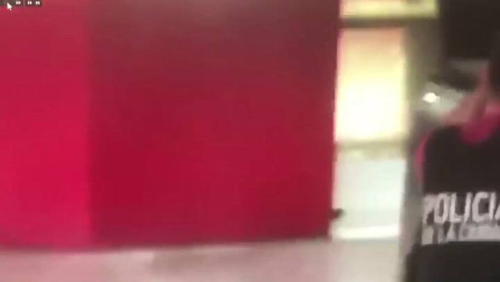 La policía rodeando el local y combatiendo la toma.