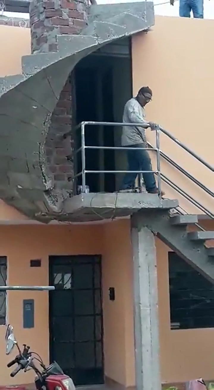 Un albañil muestra la segunda parte de la escalera mal hecha