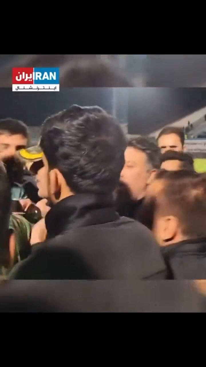An Iranian Fan Rushed Onto The Field, Attempting To Hug The Goalkeeper, With Security Intervening.