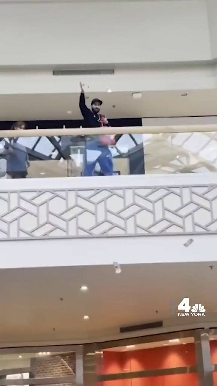 Hombre avienta dinero en un centro comercial como regalo del Día de las Madres