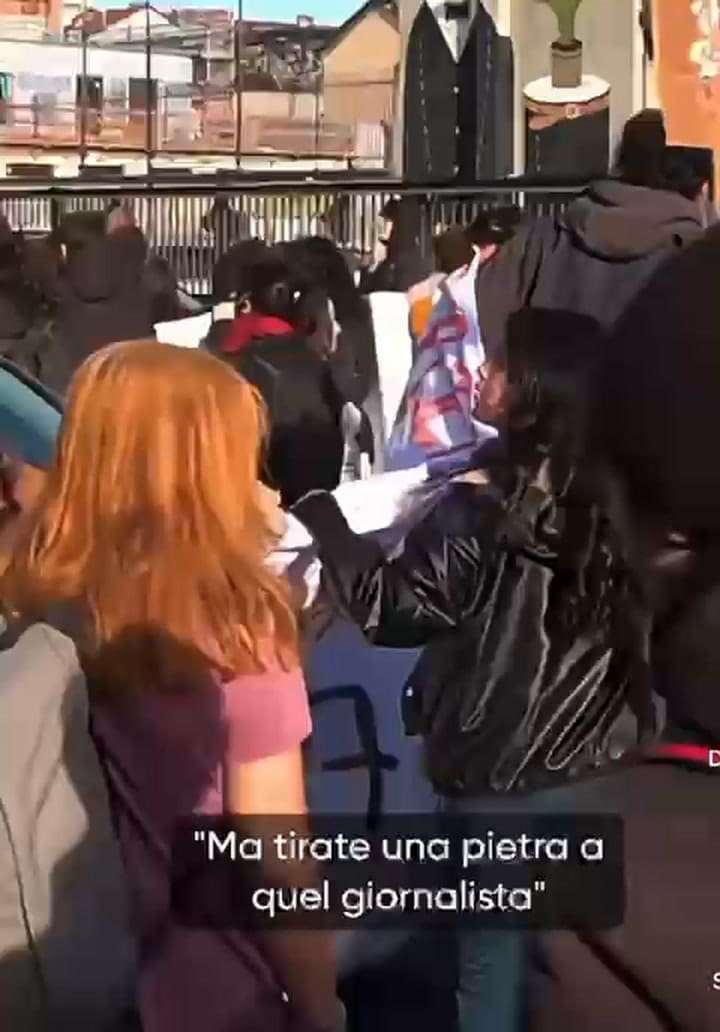 Protesters climb the bars