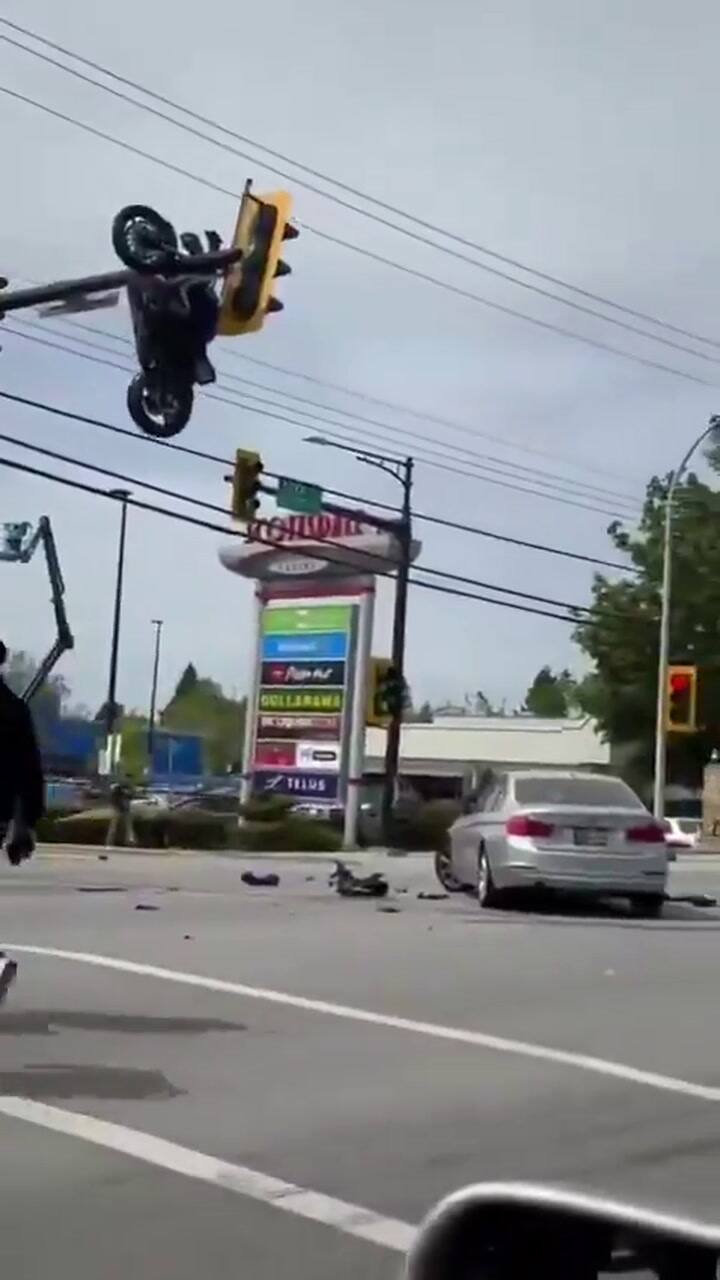 Canadá. ele colidiu com um carro, voou pelos ares e sua motocicleta acabou pendurada em um semáforo.