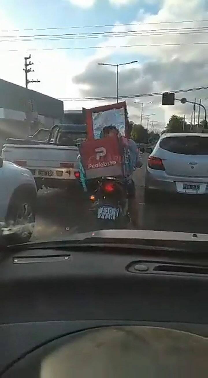 Un repartidor fue grabado cuando circulaba en moto con un menor adentro de la caja de los pedidos