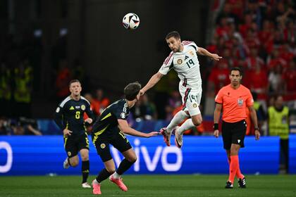 Hungary's forward #19 Barnabas Varga heads the ball during the UEFA Euro 2024 Group A football match between Scotland and Hungary at the Stuttgart Arena in Stuttgart on June 23, 2024. (Photo by Fabrice COFFRINI / AFP)