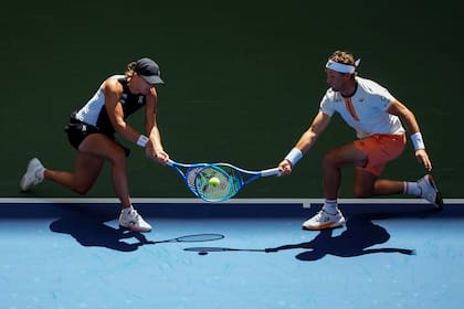 Iga Świątek y Casper Ruud devuelven un tiro simultáneamente durante su partido de dobles mixtos de primera ronda contra Madison Keys y Frances Tiafoe en el Open de Estados Unidos 2025 en Nueva York