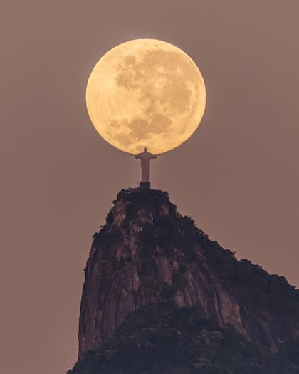 Imagen capturada por el fotógrafo brasileño Leonardo Sens en la que se ve al Cristo Redentor "sosteniendo" la luna