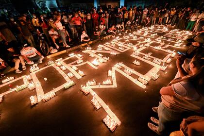 Los manifestantes rinden homenaje a los muertos con velas en las calles