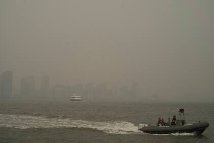 Buildings in Jersey City, N.J. are partially obscured by smoke from Canadian wildfires as boats travel on the Hudson River, seen from the Manhattan borough of New York on Tuesday, June 6, 2023. (AP Photo/Patrick Sison)