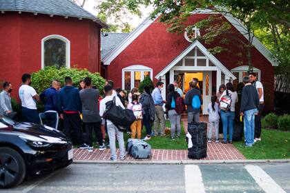 Inmigrantes se congregan frente a la iglesia episcopal de San Andrés, el 14 de septiembre del 2022, en Martha's Vineyard, Massachusetts (Ray Ewing/Vineyard Gazette vía AP)