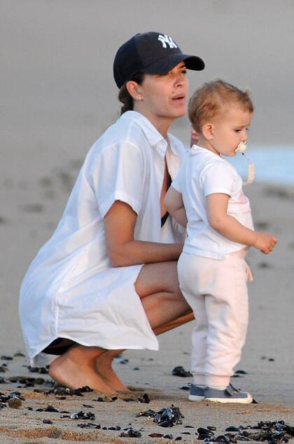 Isabel alienta a la pequeña Julia a caminar por la arena en su segundo verano en las playas de Manantiales.
