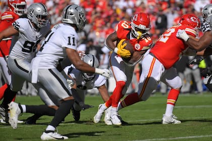 Isiah Pacheco (10), running back de los Chiefs de Kansas City, anota cerca de Jeremy Chinn (11), safety de los Raiders de Las Vegas, durante la segunda mitad de un juego de fútbol americano de la NFL el domingo 19 de octubre de 2025, en Kansas City, Misuri. (AP Photo/Reed Hoffmann)