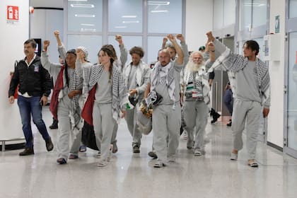 Italian members of the Global Sumud Flotilla arrive at the Fiumicino Airport in Rome on Thursday, May 21, 2026, after they were released and deported by the Israeli government after attempting to reach Gaza. (Cecilia Fabiano/LaPresse via AP)