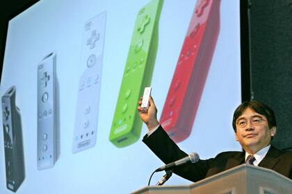 Iwata junto al control de mando de la Wii