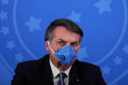 Jair Bolsonaro, con barbijo, durante una conferencia de prensa; el presidente de Brasil se sometió dos veces al test por coronavirus y dio negativo