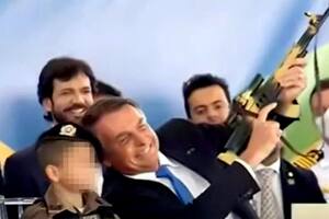 La imagen de Bolsonaro con un rifle de juguete junto un chico vestido de militar