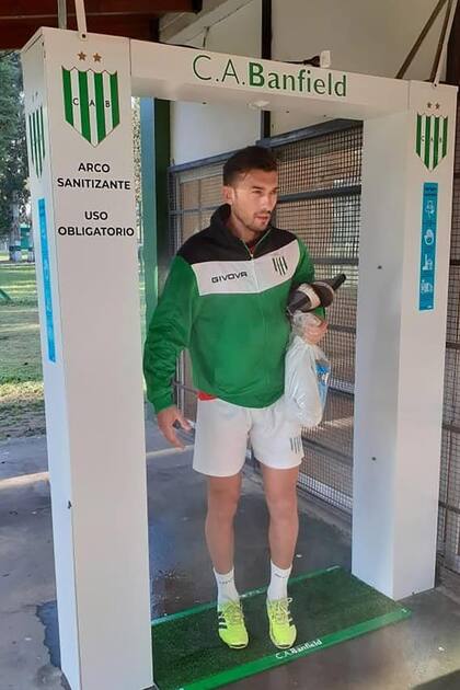 Jesús Dátolo pasando por un “arco sanitizante” de uso obligatorio antes de terminar de cambiarse para entrenarse con Banfield
