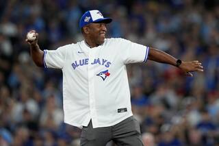 Joe Carter luce chaqueta de jonrón de Azulejos tras lanzar 1ra bola en 2do juego de Serie Mundial