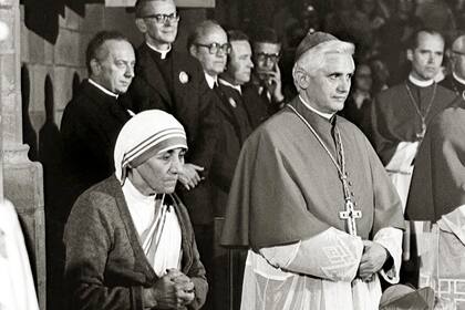 En esta foto de archivo de septiembre de 1978 proporcionada por la Agencia Católica Alemana de Noticias KNA, la Madre Teresa de origen albanés, a la izquierda, y el cardenal alemán Joseph Ratzinger, a la derecha, asisten a una misa durante el 85º Día de los Católicos Alemanes en Friburgo