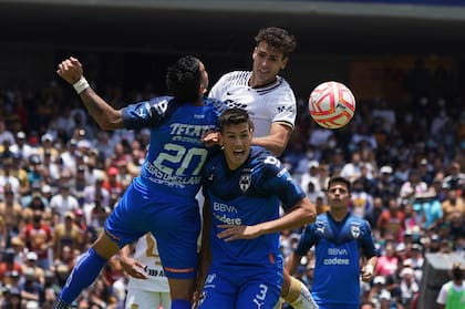 Juan Ignacio Dinenno gana en el salto ante dos rivales de Monterrey en un partido por la Liga MX.