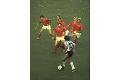Junio de 1982:  "Una imagen que perpetuó su reputación de jugador intrépido y singularmente hábil en su debut en la Copa del Mundo de 1982. Su perspectiva comprimida hace que parezca que está en juego abierto, pero en realidad está entre la muralla belga cuando ésta se deshizo tras un tiro libre ejecutado en corto".