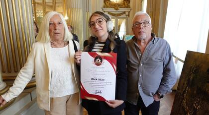 Junto a sus padres, recibiendo un reconocimiento.