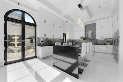 Kun Agüero, Miami. Interiores. Cocina, con una puerta vidriada que da a un patio andaluz con una fuente en el centro