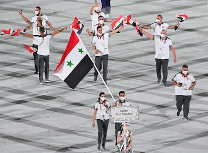 La abanderada de Siria, Hend Zaza, y el abanderado de Siria, Ahmad Saber Hamcho, y su delegación desfilan durante la ceremonia de apertura de los Juegos Olímpicos de Tokio 2020, en el Estadio Olímpico de Tokio, el 23 de julio de 2021