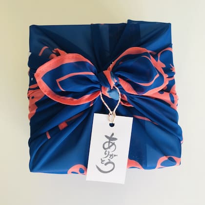 La caja de dulces viene envuelta en un furoshiki diseñado temáticamente.
