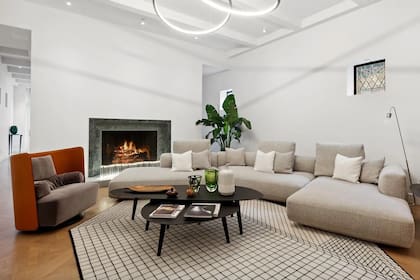 La casa cuenta con techos de doble altura, tres chimeneas a gas y pisos de madera noble en todo el departamento.