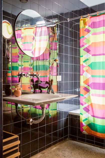 La cortina del baño ( (Ikea) rompe con la sobriedad de los materiales.