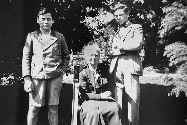 Klaus y Helmut con su abuela materna Dutta y la casa Haus Berchtesgaden (1936), la primera casa construida de material, donde la familia veraneaba y recibía amigos; todavía está en pie en el predio del hotel La Cumbrecita