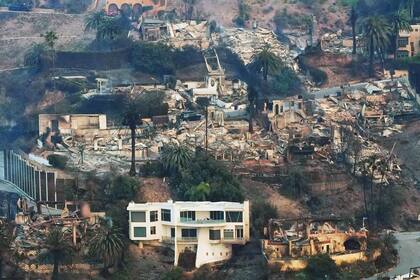La devastación causada por el incendio de Palisades se ve desde el aire, mientras una casa permanece en pie en el vecindario de Pacific Palisades en Los Ángeles.