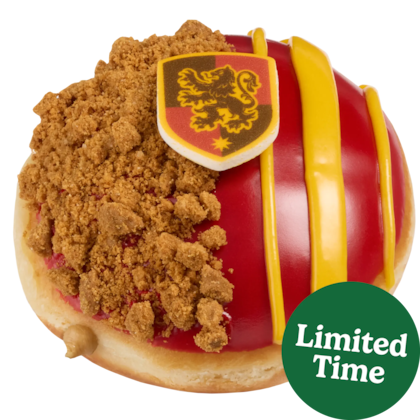 La dona Gryffindor está rellena de crema sabor a crema de galleta, con cobertura roja y trozos de Biscoff,