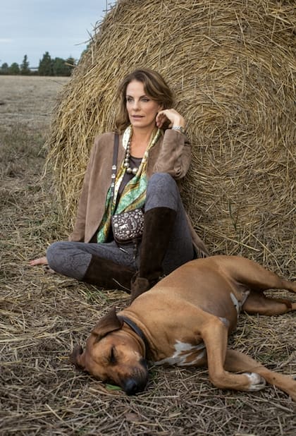 La exmodelo, con poncho de gamuza y collar antiguo de plata peruana, posa al lado de Roma, su inseparable rodesiana