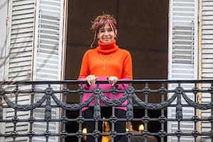La expresidenta argentina Cristina Kirchner observa desde el balcón de su residencia, donde cumple arresto domiciliario en Buenos Aires, a simpatizantes que se congregaron para pedir su libertad, el 17 de agosto de 2025