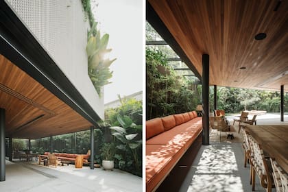 La galería exterior conecta el interior y la naturaleza: cubierta de madera y estructura metálica genera continuidad visual, mientras el mobiliario lineal y la vegetación integrada refuerzan la sensación de apertura y confort.