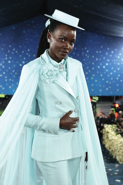 La ganadora del Oscar
Lupita Nyong’o desfiló un traje
estructurado en cr
êpe de seda
turquesa, de Chanel, con broche
de camelia sobre la solapa,
vaporosa capa y un sombrero
a tono.