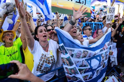 La gente celebra en la Plaza de los Rehenes en Tel Aviv cuando se supo que un convoy de la Cruz Roja está en camino para recoger a un segundo grupo de rehenes israelíes que serán liberados por Hamás el 13 de octubre de 2025