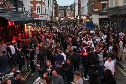 Los juerguistas llenan una calle fuera de los bares en el área de Soho de Londres, luego que las restricciones se aliviaron aún más durante la nueva pandemia de coronavirus
